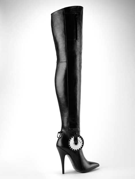 A dominatrix thigh boot with a variety of daring accessories, seen here with a dramatic kinky pinwheel