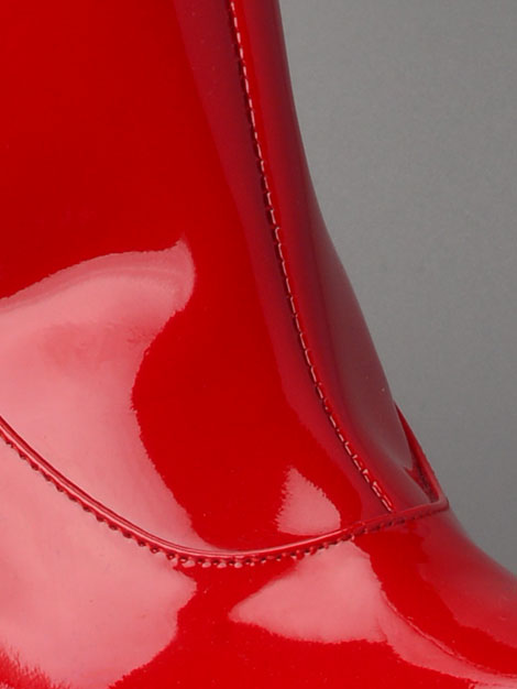 Perfect stitching seen in the Italian patent leather upper of our extravagantly kinky red point boot