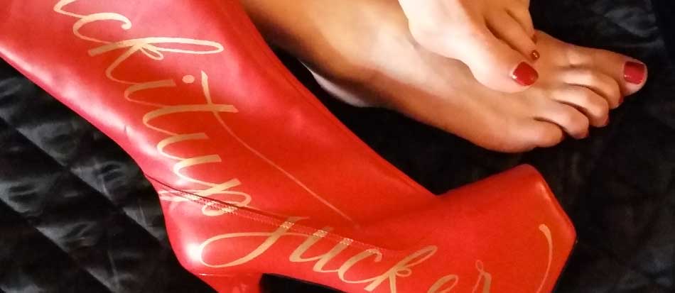 Lady Bellatrix wears the #suckitupfucker unique hand-decorated red plug boots