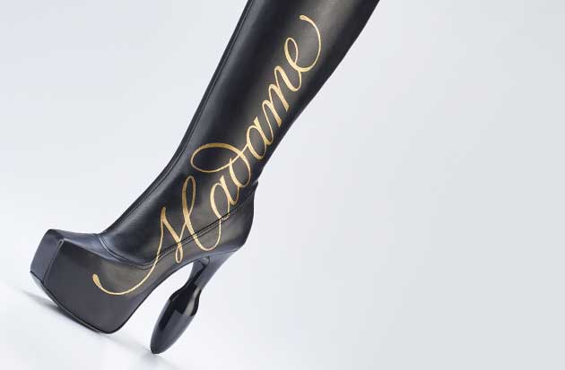 Unique hand-decorated buttplug heel boots with custom hand lettering for dominatrix